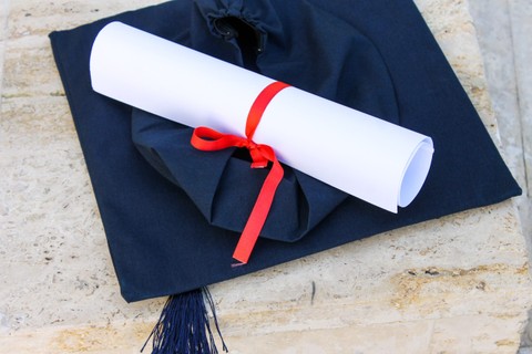 A graduation cap and scroll