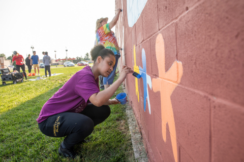 Grinnell College students painting a mural